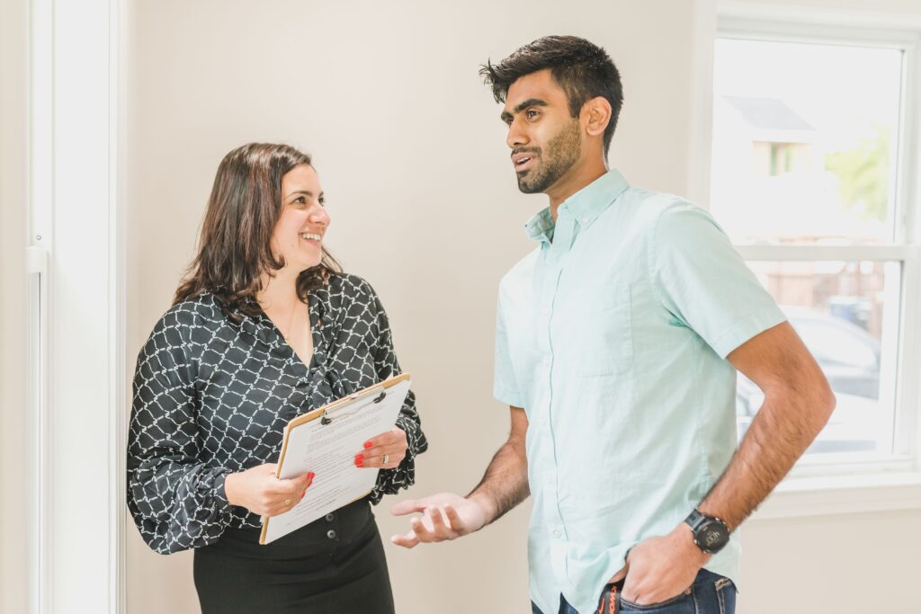 A homeowner discussing property details with a professional indoors