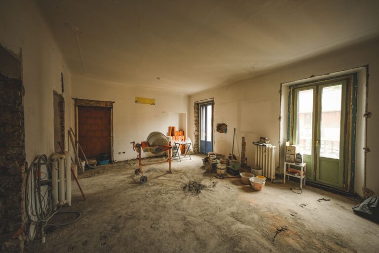 A bright room under renovation with construction materials and tools